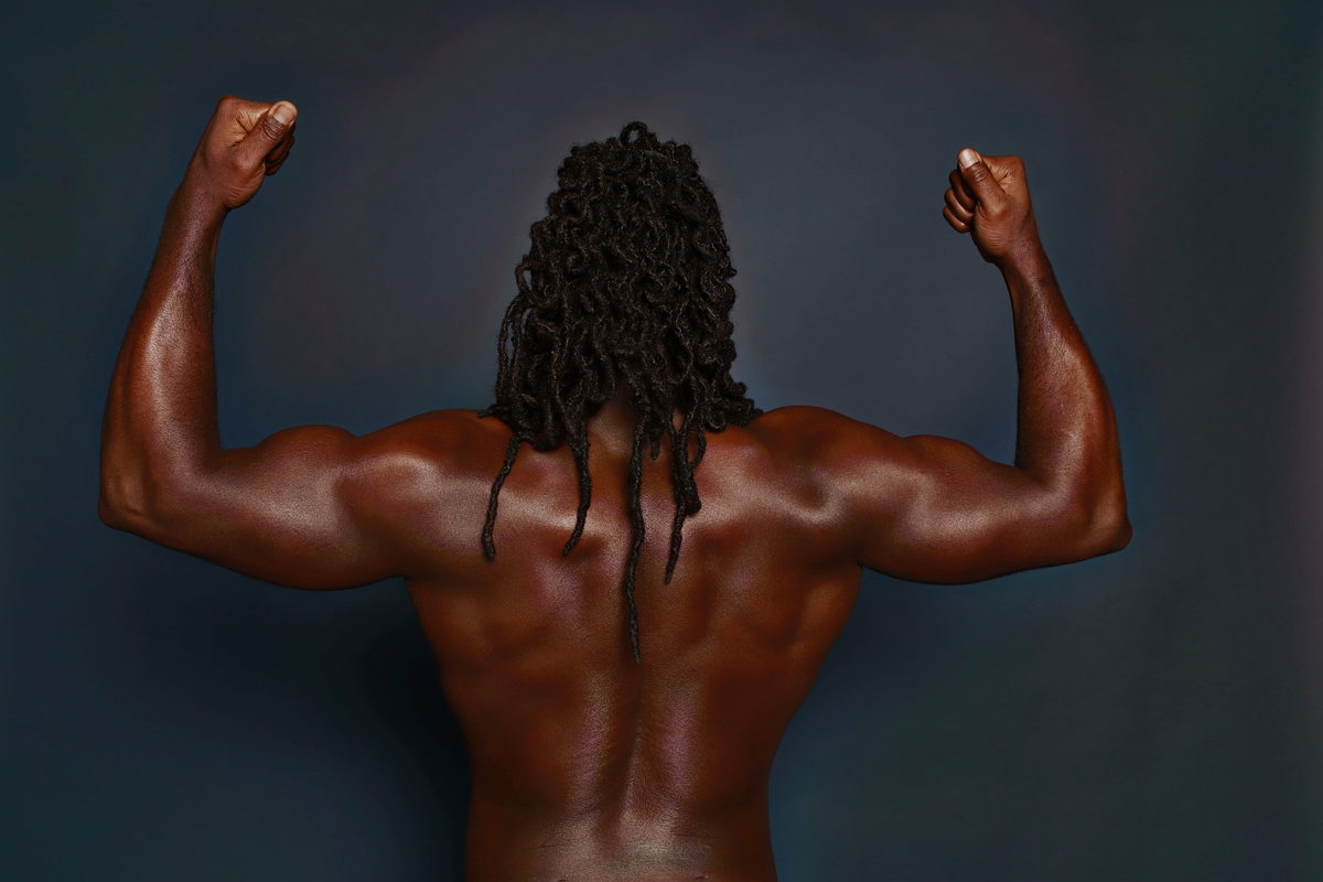 Studio dark, back double biceps pose.